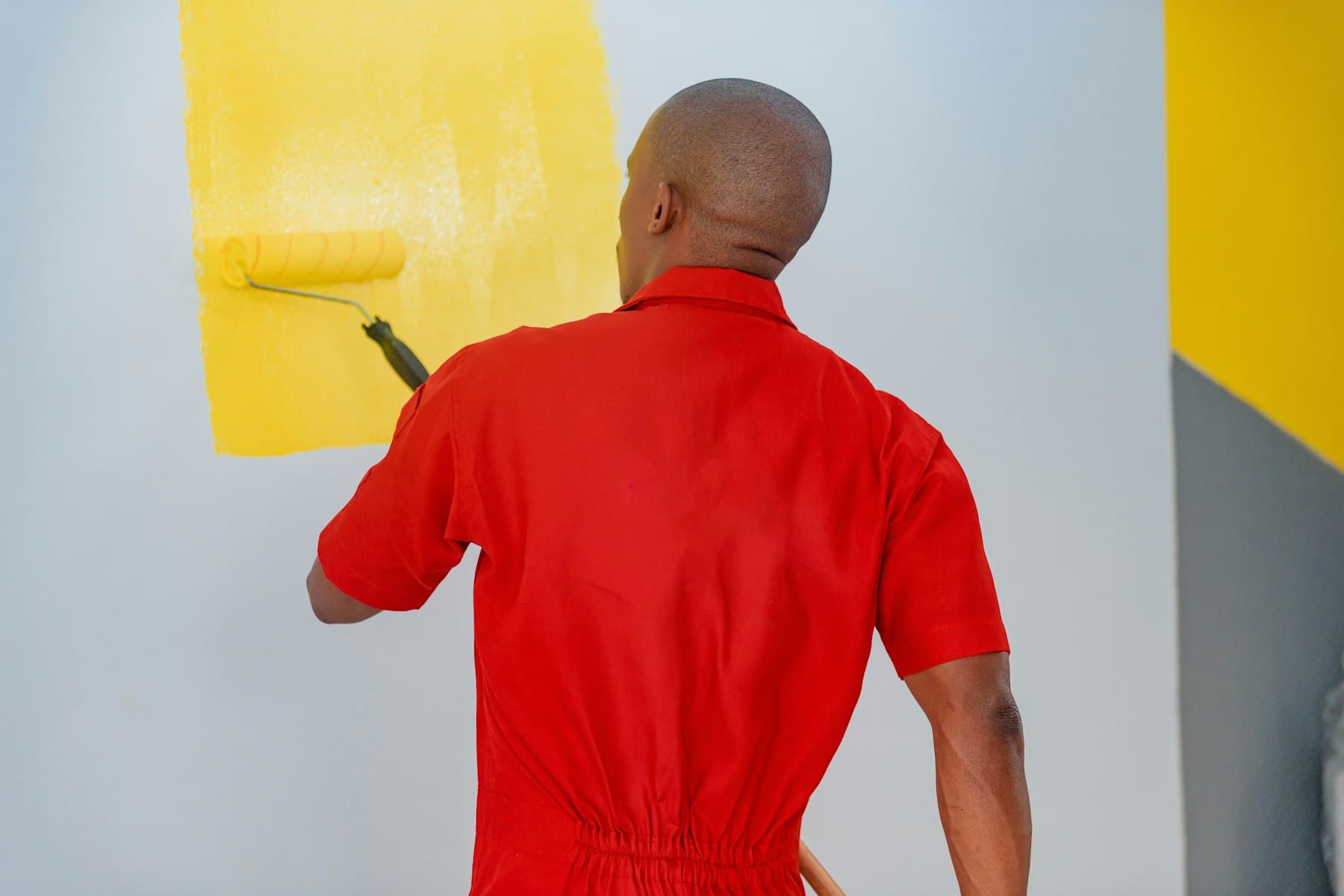 Painter rolling a fresh coat onto an interior wall